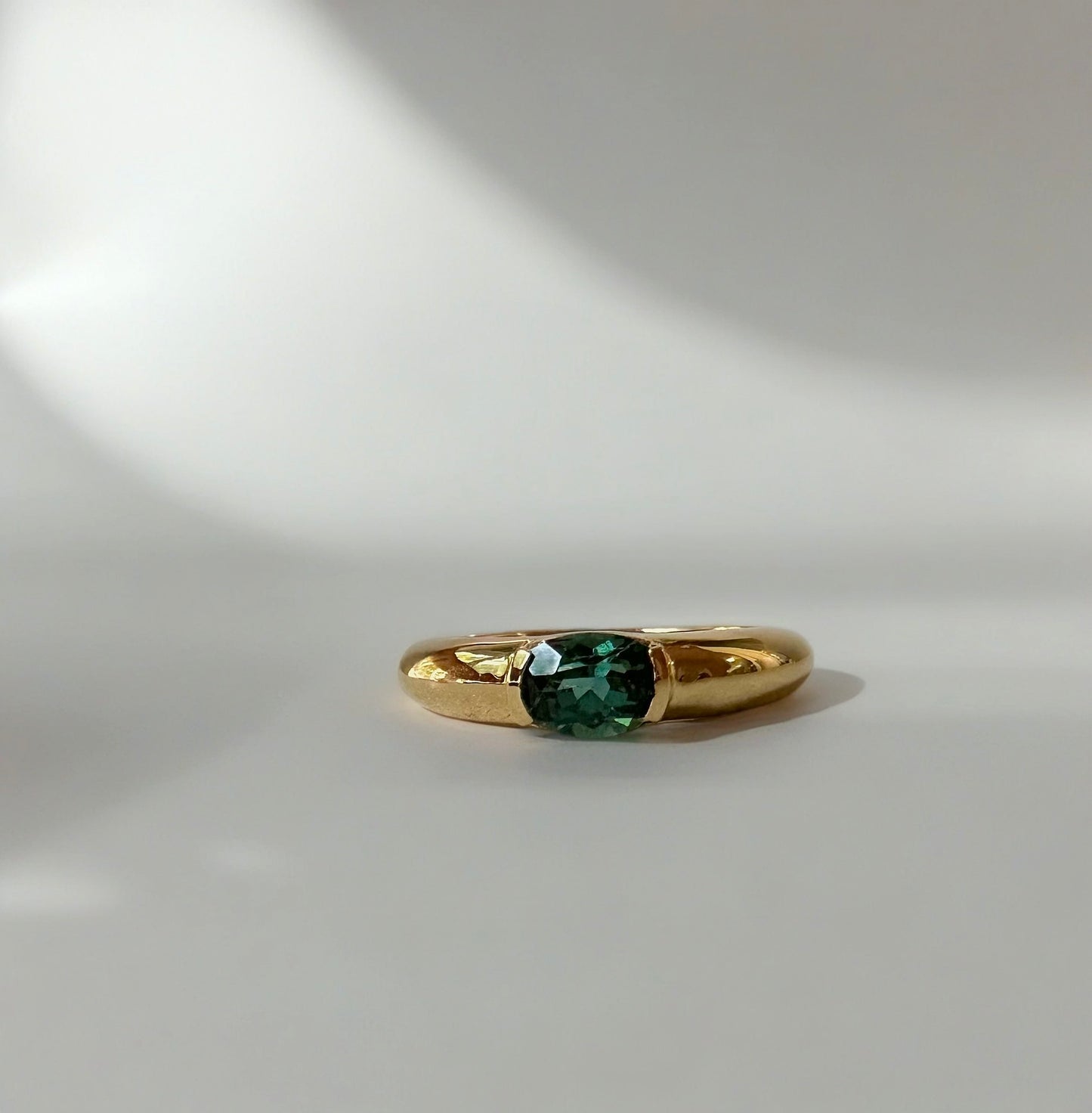 Blue Tourmaline ring featuring a blue tourmaline 1ct stone at its center, half bezel set and handcrafted in 18k gold | Ella Creations Jewelry