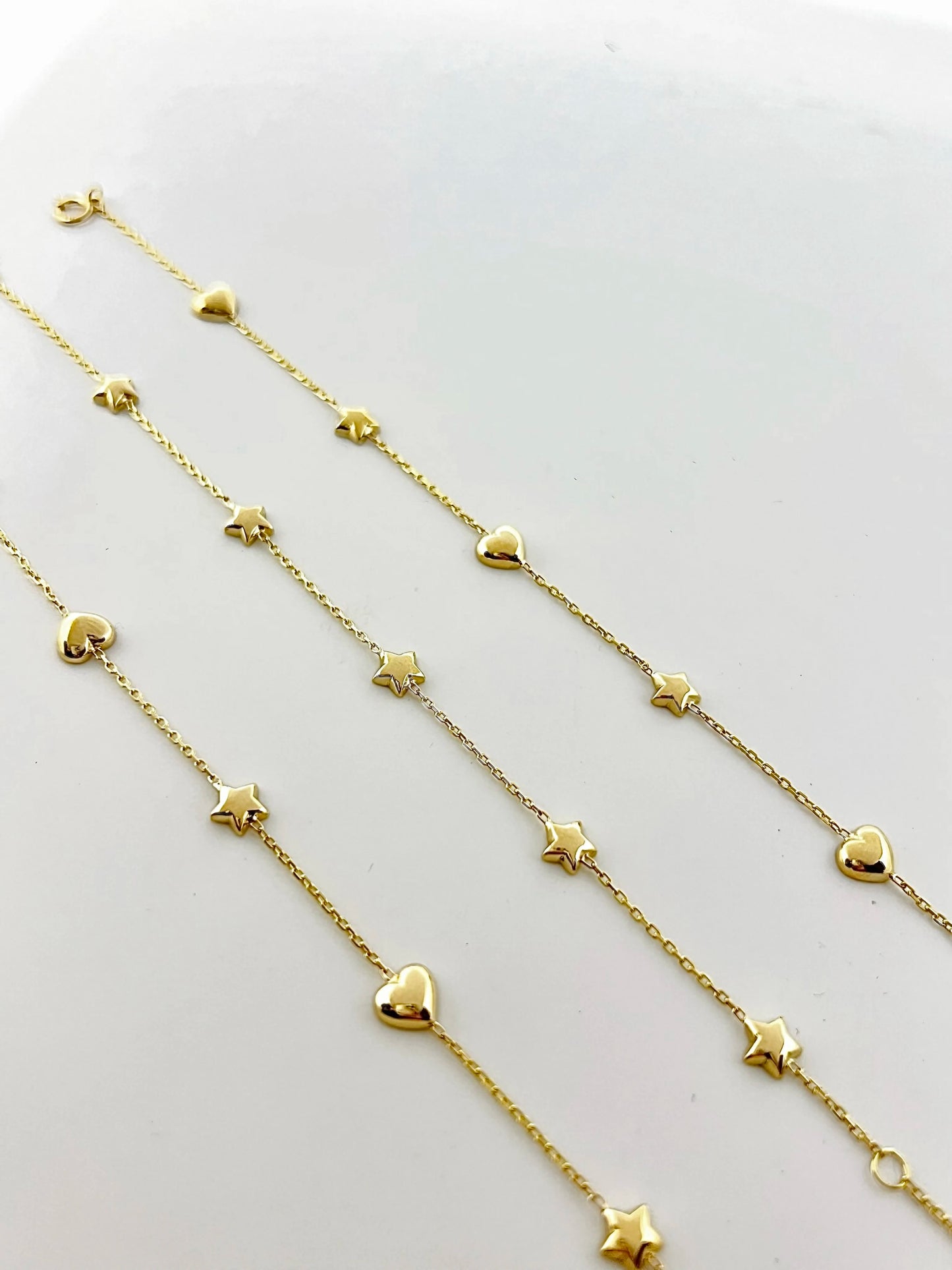 Chain Bracelet with Stars featuring five small puffy star charms or in alternative Stars and Hearts charms. This bracelet is perfect as everyday bracelet as it's handcrafted in 18 karat gold ensuring lifetime luster and resistance to tarnishing.&nbsp;