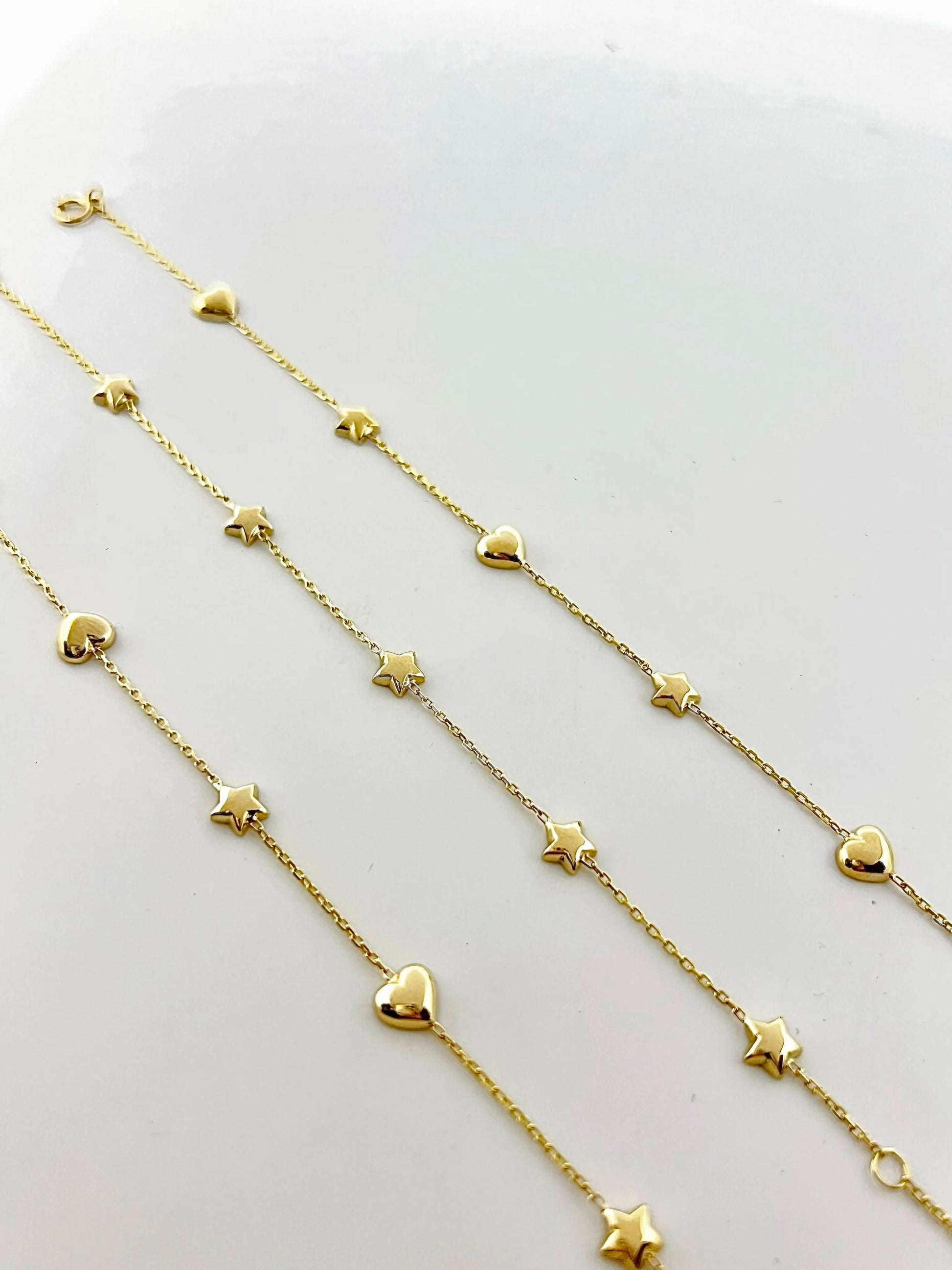 Chain Bracelet with Stars featuring five small puffy star charms or in alternative Stars and Hearts charms. This bracelet is perfect as everyday bracelet as it's handcrafted in 18 karat gold ensuring lifetime luster and resistance to tarnishing.&nbsp;