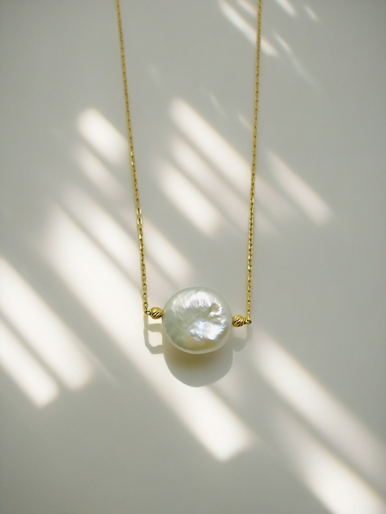 Long pearl gold necklace, featuring a coin edge pearl with gold bead and 18k chain | Ella Creations Jewelry