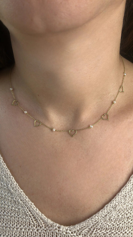 Dainty and light weight solid gold necklace featuring Fresh water Pearls and open-heart charms securely affixed at evenly spaced intervals. This necklace is handcrafted in 18 karat gold ensuring lifetime luster and resistance to tarnishing. | Ella Creations Jewelry