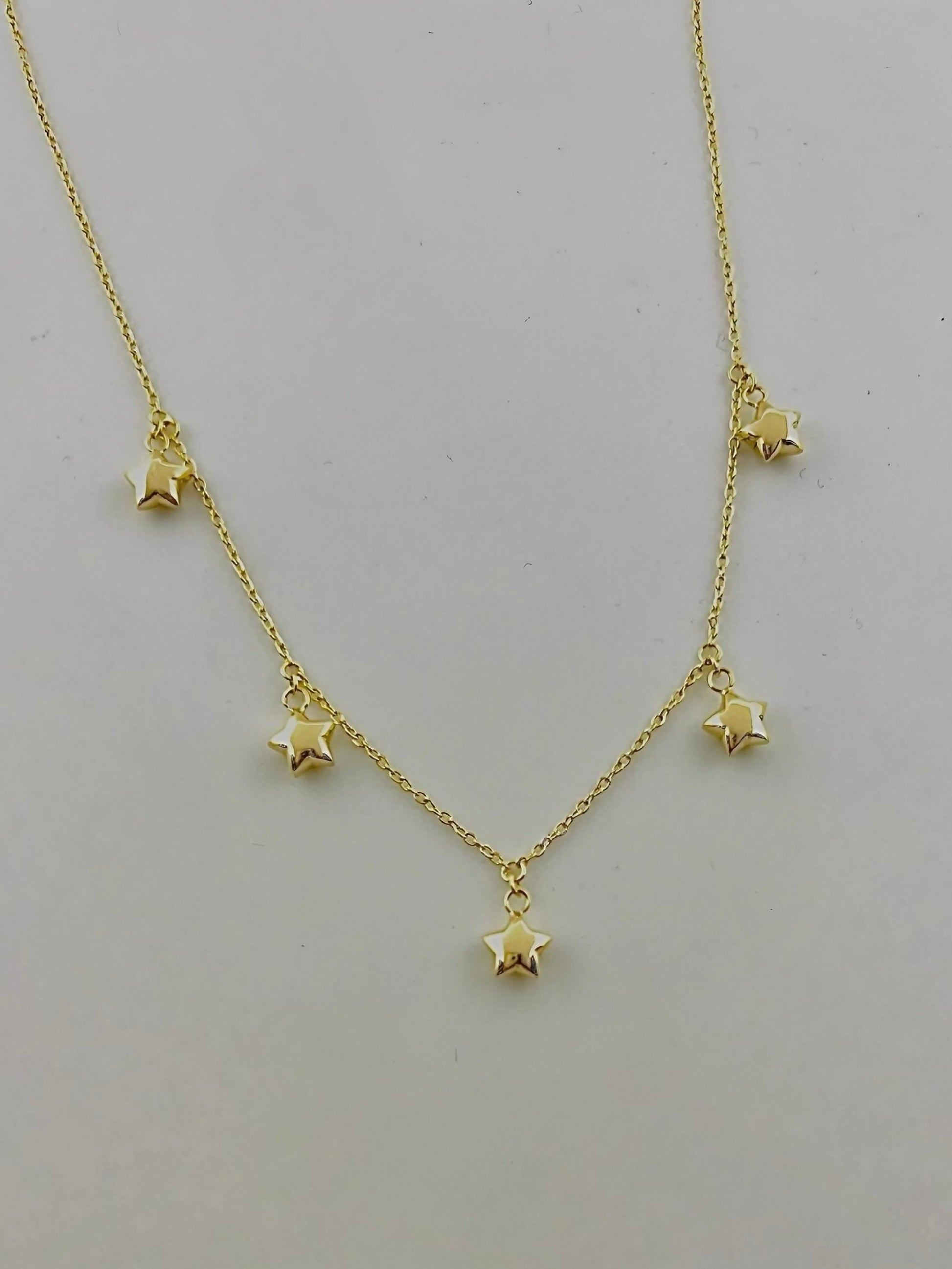 Gold Stars Necklace featuring dangling puffy stars in 18 karat Gold available in 16" and can be customized | Ella Creations Jewelry