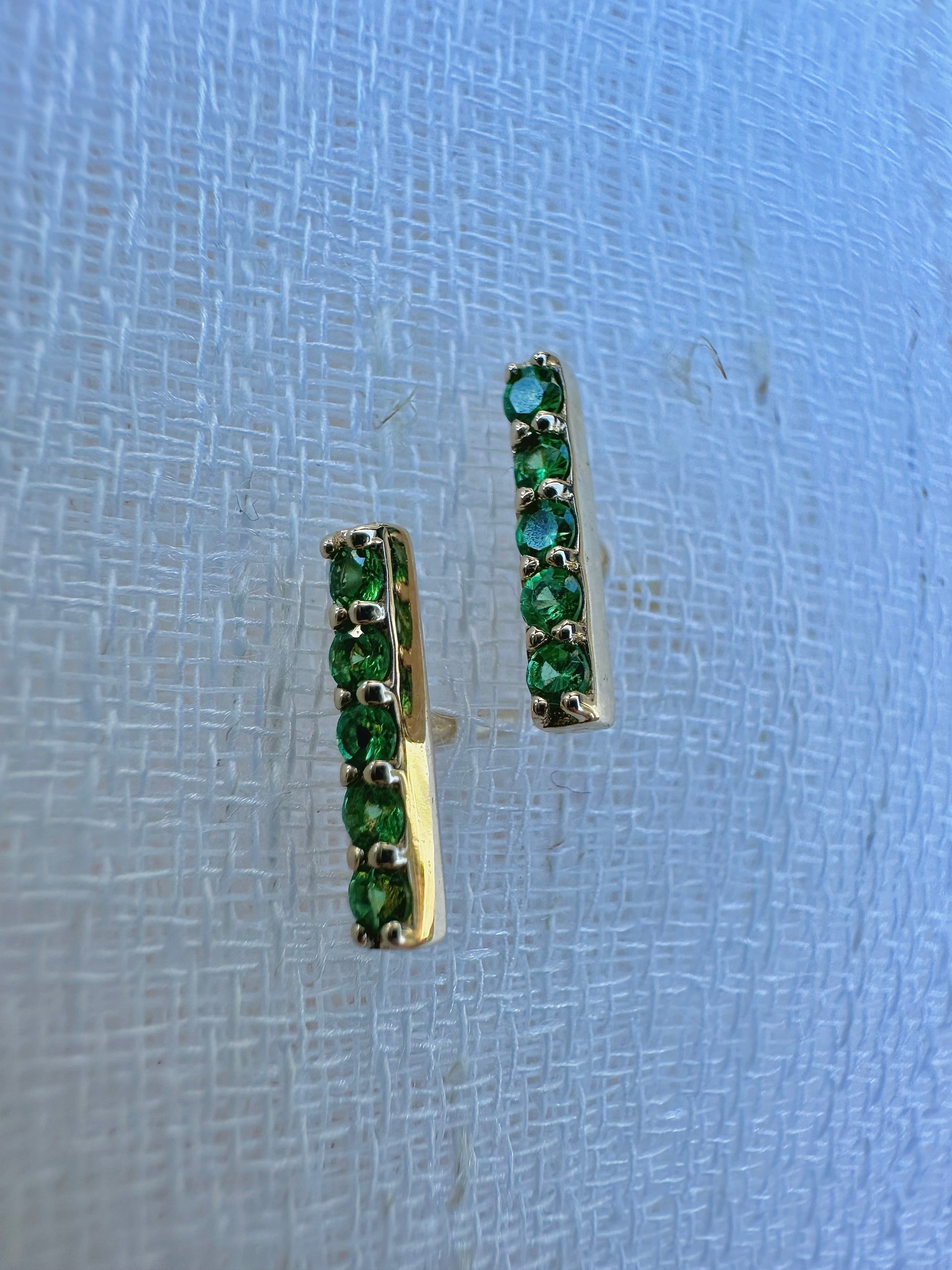 Beautiful and sleek Bar stud earrings adorned with 1.7mm round natural Tsavorite gemstones. Handcrafted in 18 karat Gold, these Bar Stud Earrings have a linear design that makes them comfortable for everyday wear. Sold as pair | Ella Creations Jewelry