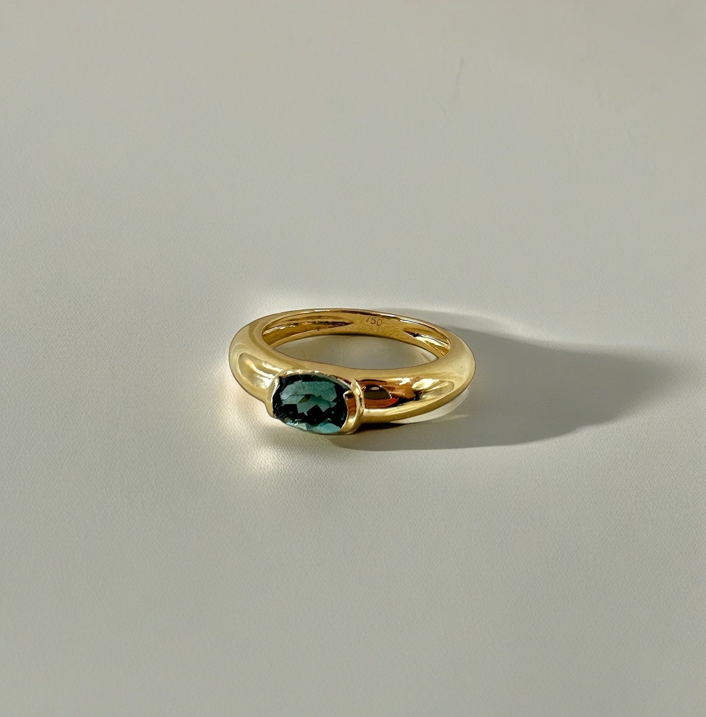 Blue Tourmaline ring featuring a blue tourmaline 1ct stone at its center, half bezel set and handcrafted in 18k gold | Ella Creations Jewelry