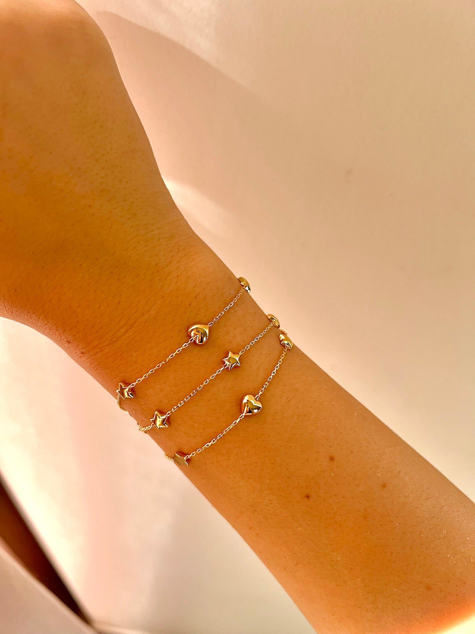 Chain Bracelet with Stars featuring five small puffy star charms or in alternative Stars and Hearts charms. This bracelet is perfect as everyday bracelet as it's handcrafted in 18 karat gold ensuring lifetime luster and resistance to tarnishing.&nbsp;