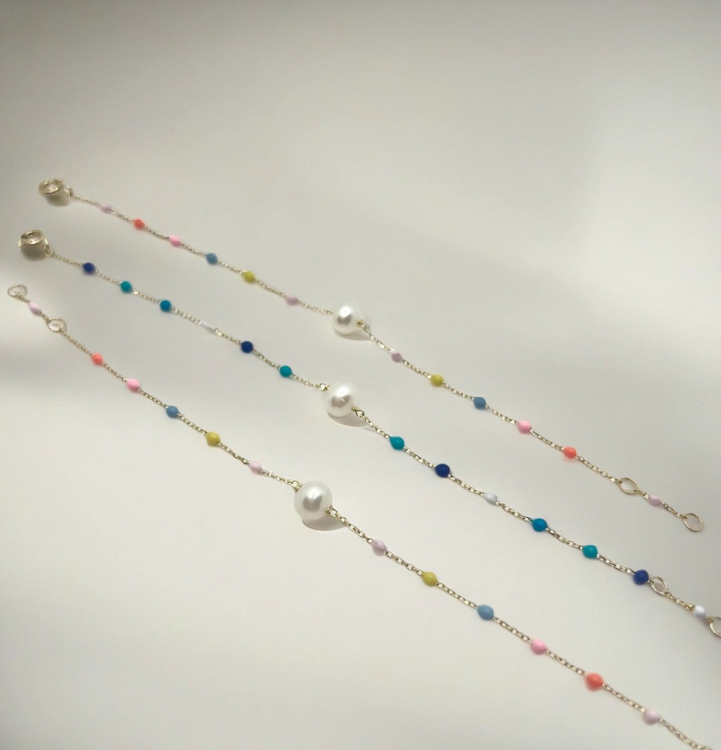 stunning Pearl Bracelet Delicately crafted in a 18 karat gold chain, and featuring a series of enamel beads in a delightful array of colors | Ella Creations Jewelry