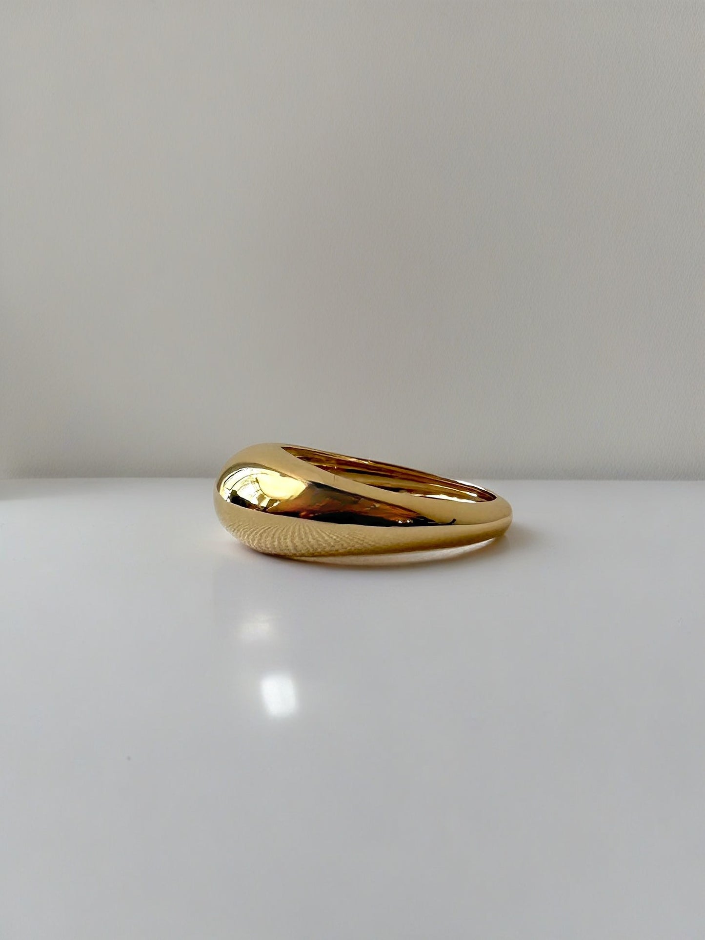 Gold Dome Ring handcrafted in 18k gold, the ban tampers from 7.5mm to 3mm | Ella Creations Jewelry 