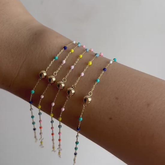 Gold Ball Bracelet. Delicately crafted in 18k solid gold fine chain, featuring a gold bead at its center and colorful enamel beads spaced along the chain, creating a harmonious and eye-catching design | Ella Creations Jewelry