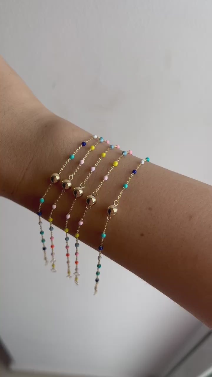 Gold Ball Bracelet. Delicately crafted in 18k solid gold fine chain, featuring a gold bead at its center and colorful enamel beads spaced along the chain, creating a harmonious and eye-catching design | Ella Creations Jewelry