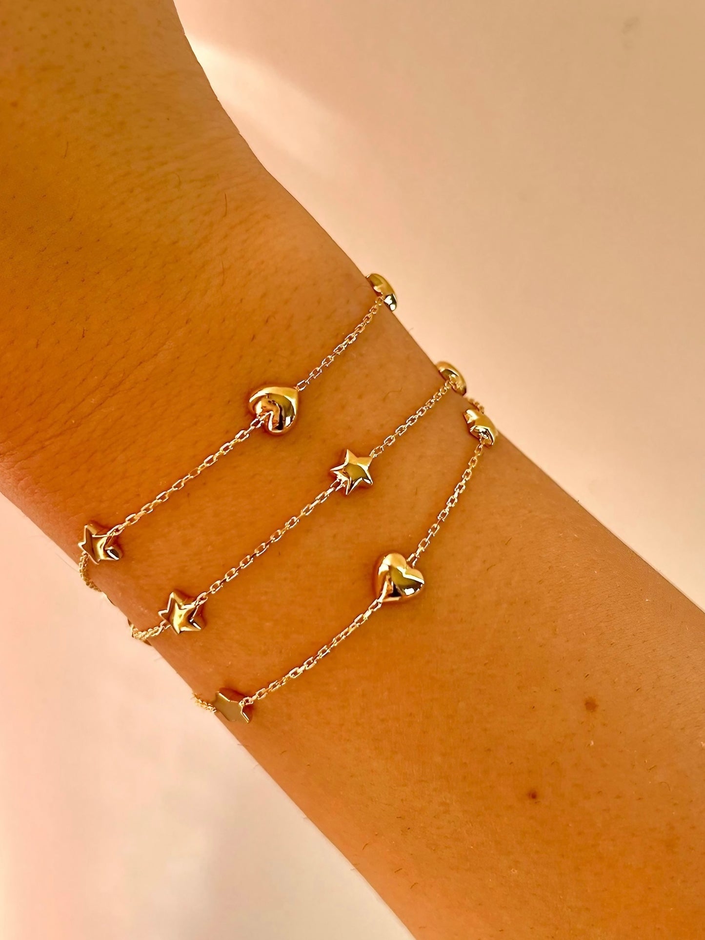 Chain Bracelet with Stars featuring five small puffy star charms or in alternative Stars and Hearts charms. This bracelet is perfect as everyday bracelet as it's handcrafted in 18 karat gold ensuring lifetime luster and resistance to tarnishing.&nbsp;