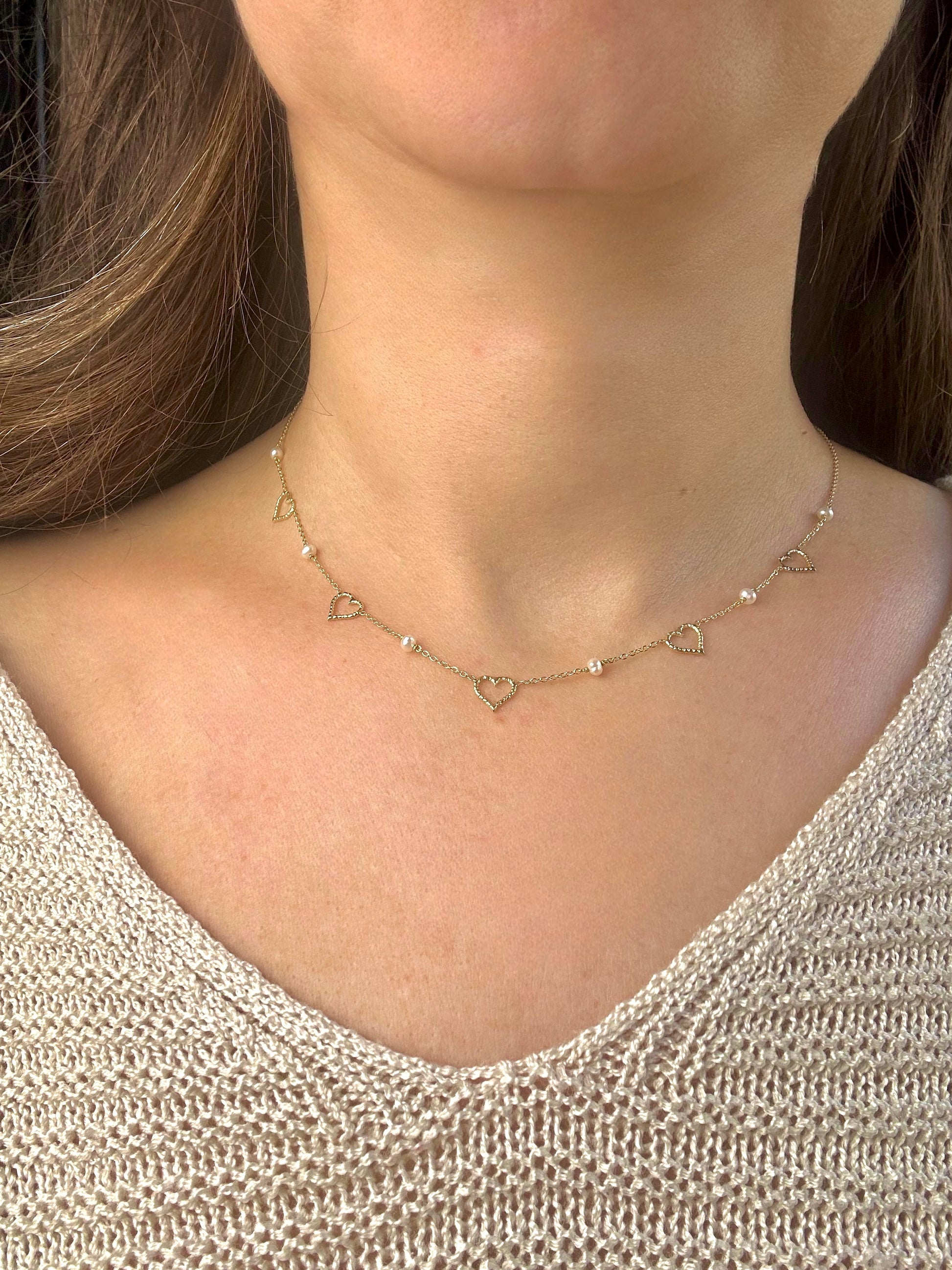 Dainty and light weight solid gold necklace featuring Fresh water Pearls and open-heart charms securely affixed at evenly spaced intervals. This necklace is handcrafted in 18 karat gold ensuring lifetime luster and resistance to tarnishing. | Ella Creations Jewelry