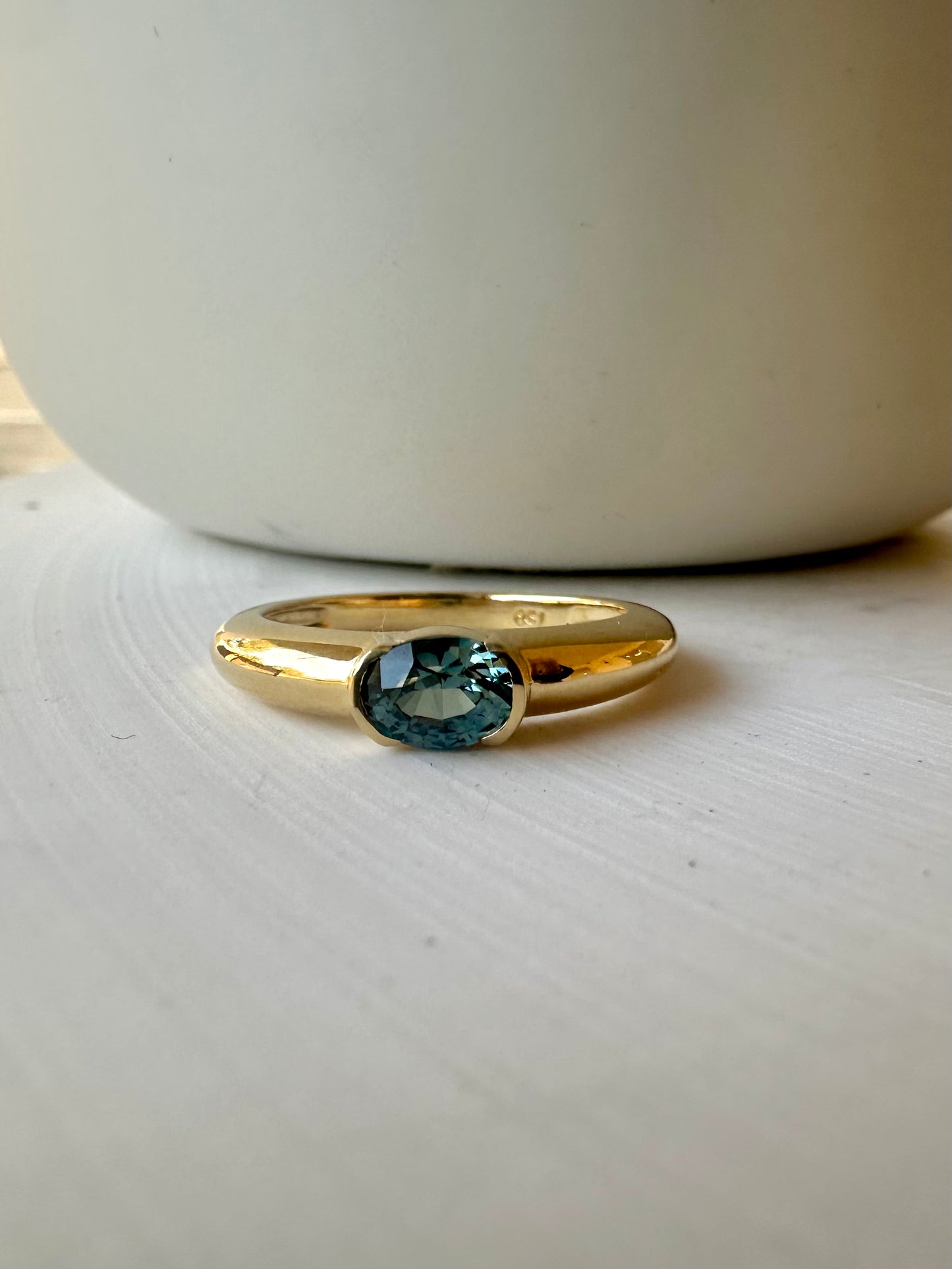 Captivating dome ring featuring a half bezel-set oval stone at its center. This stunning ring handcrafted in luxurious 18 karat gold band, allows for personalization with a variety of high-quality stones | Ella Creations Jewelry