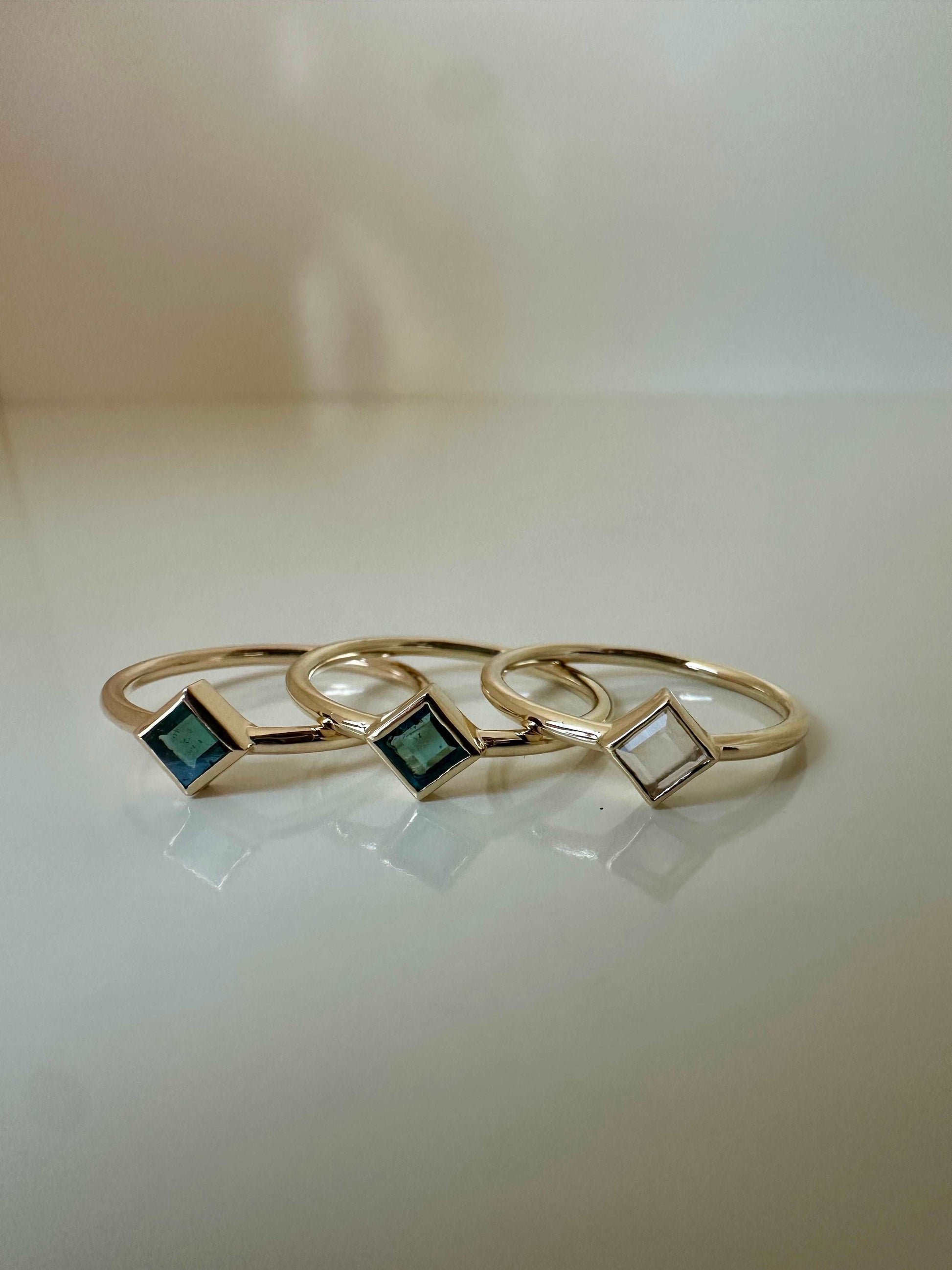 Elegant and dainty Rhombus rings,  Handcrafted in 18k solid yellow gold, each features a thin band ring with a unique Rhombus bezel setting that showcases clear quartz, tourmaline  stones | Ella Creations Jewelry