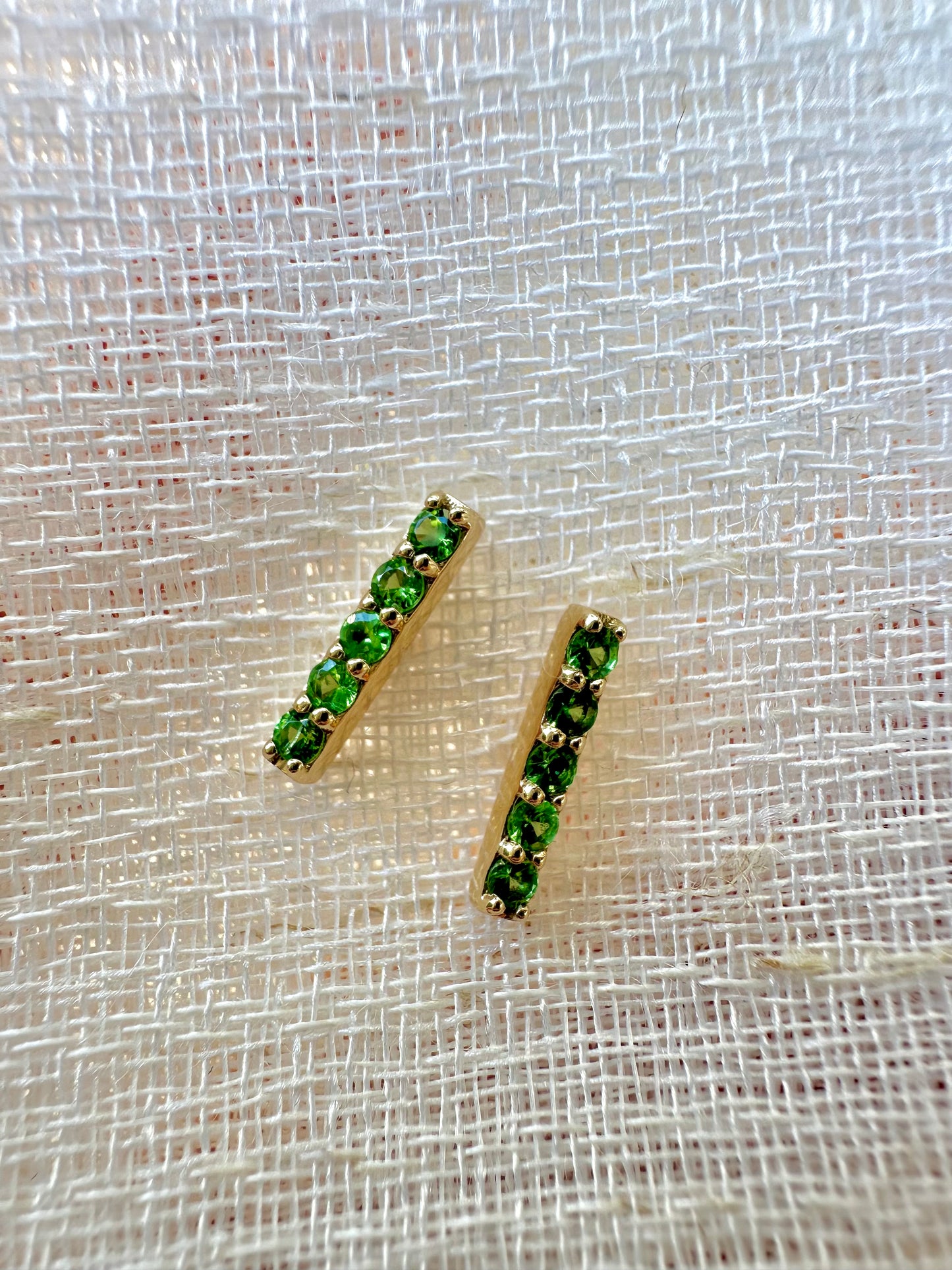 Beautiful and sleek Bar stud earrings adorned with 1.7mm round natural Tsavorite gemstones. Handcrafted in 18 karat Gold, these Bar Stud Earrings have a linear design that makes them comfortable for everyday wear. Sold as pair | Ella Creations Jewelry