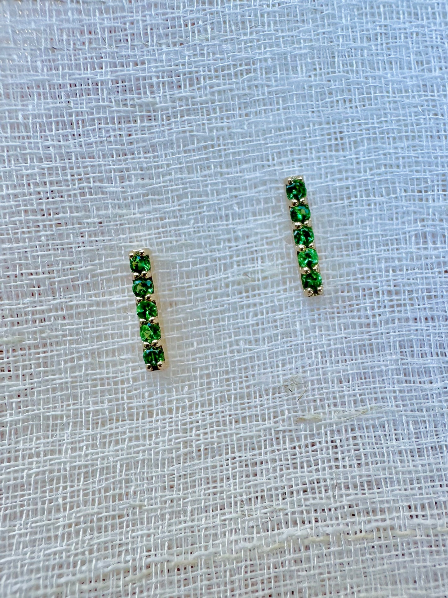 Beautiful and sleek Bar stud earrings adorned with 1.7mm round natural Tsavorite gemstones. Handcrafted in 18 karat Gold, these Bar Stud Earrings have a linear design that makes them comfortable for everyday wear. Sold as pair | Ella Creations Jewelry